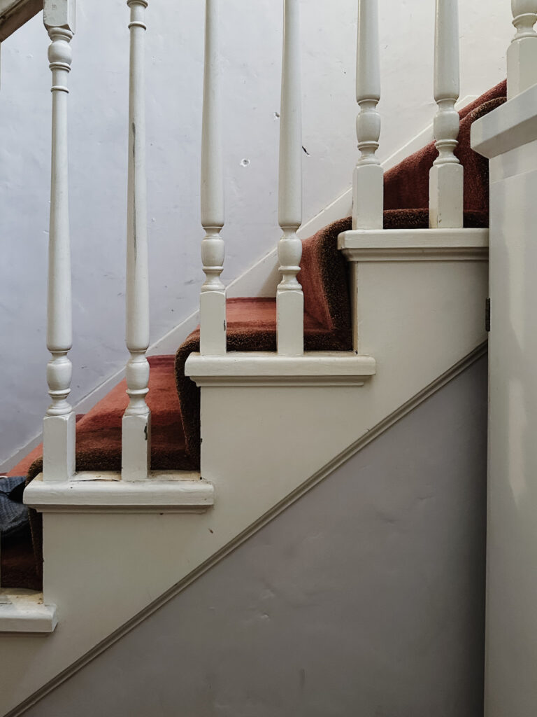 stair case with red carpet