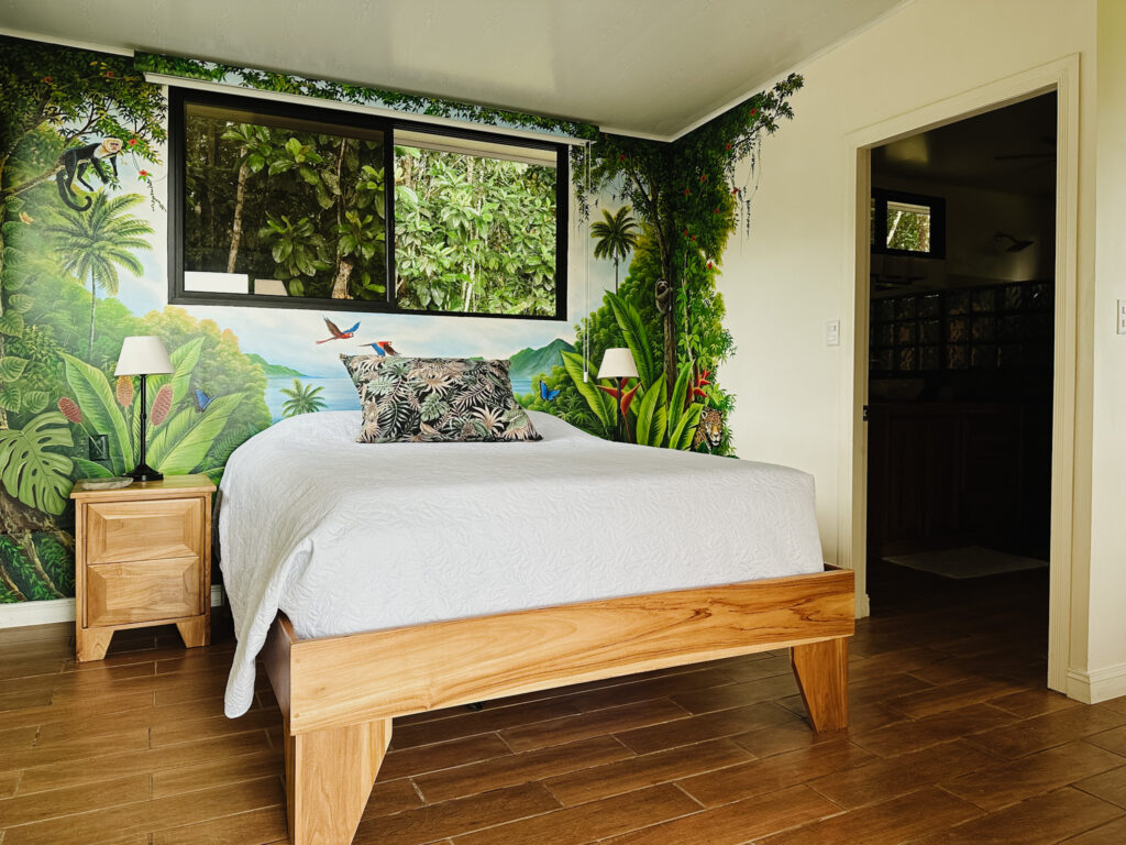 jungle mural on back wall, costa rica casita, wood bed frame and nightstands